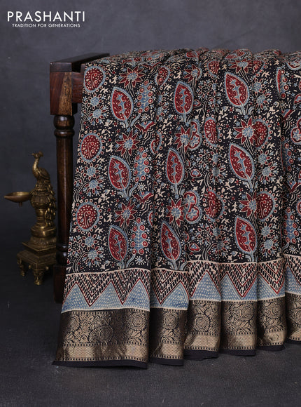 Dola silk saree black with allover ajrakh prints and zari woven border