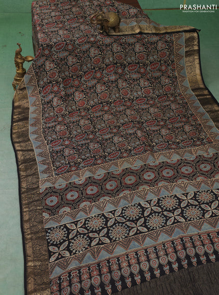 Dola silk saree black with allover ajrakh prints and zari woven border