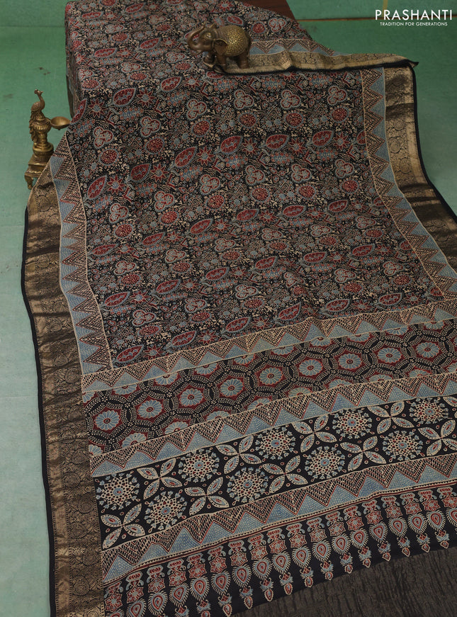 Dola silk saree black with allover ajrakh prints and zari woven border