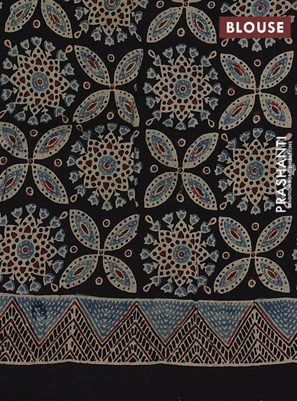 Dola silk saree black with allover ajrakh prints and zari woven border