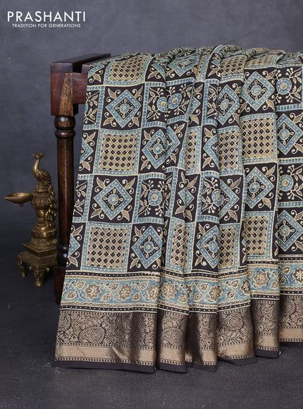 Dola silk saree blue shade and black with allover ajrakh prints and zari woven border