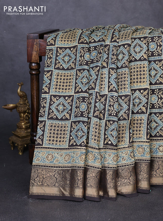 Dola silk saree blue shade and black with allover ajrakh prints and zari woven border