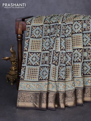 Dola silk saree blue shade and black with allover ajrakh prints and zari woven border