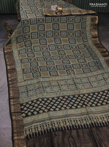 Dola silk saree blue shade and black with allover ajrakh prints and zari woven border