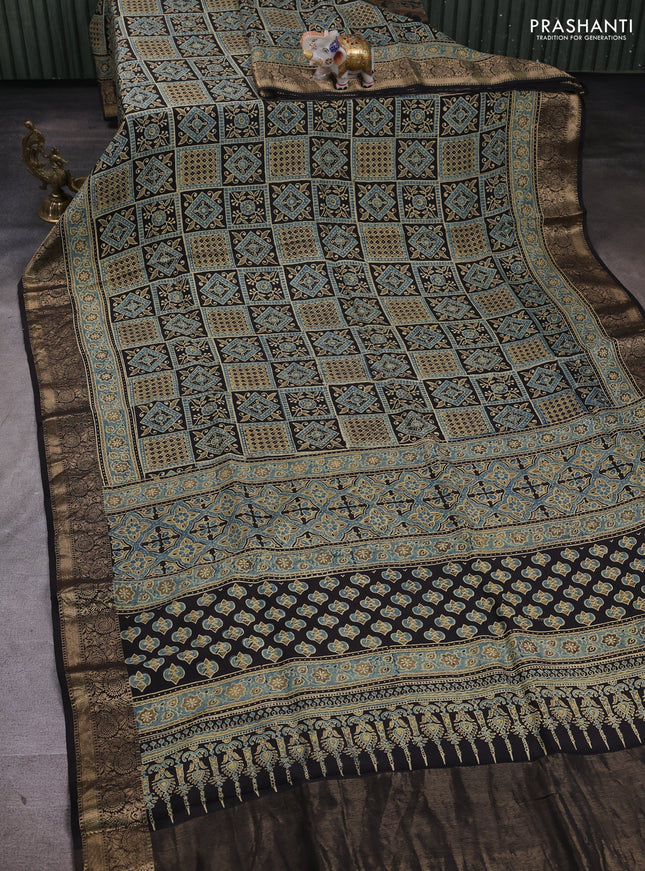 Dola silk saree blue shade and black with allover ajrakh prints and zari woven border