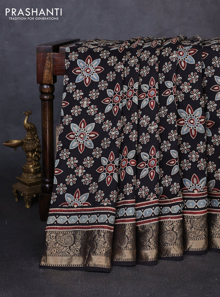 Dola silk saree black with allover butta prints and zari woven border