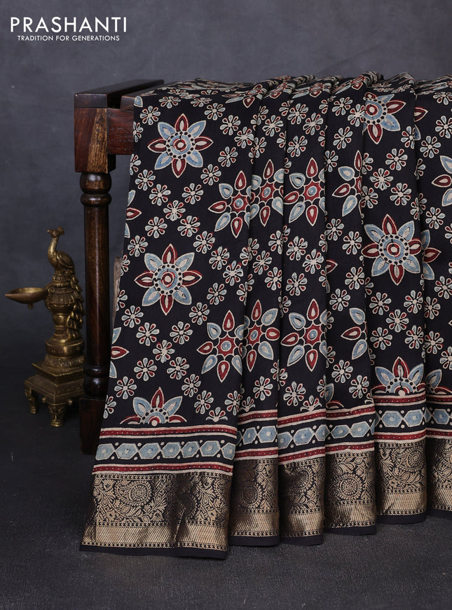 Dola silk saree black with allover butta prints and zari woven border