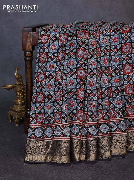 Dola silk saree black and maroon with allover ajrakh prints and zari woven border
