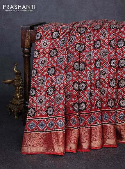 Dola silk saree maroon with allover ajrakh prints and zari woven border