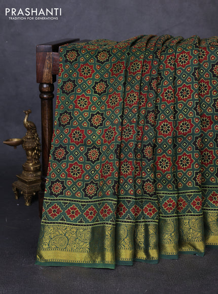 Dola silk saree green shade with allover ajrakh prints and zari woven border