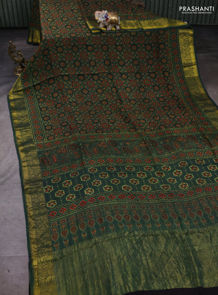 Dola silk saree green shade with allover ajrakh prints and zari woven border