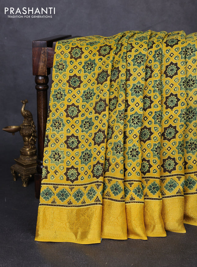 Dola silk saree yellow with allover ajrakh prints and zari woven border