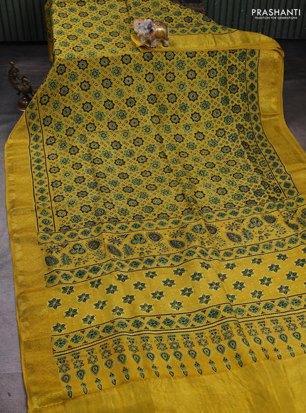 Dola silk saree yellow with allover ajrakh prints and zari woven border