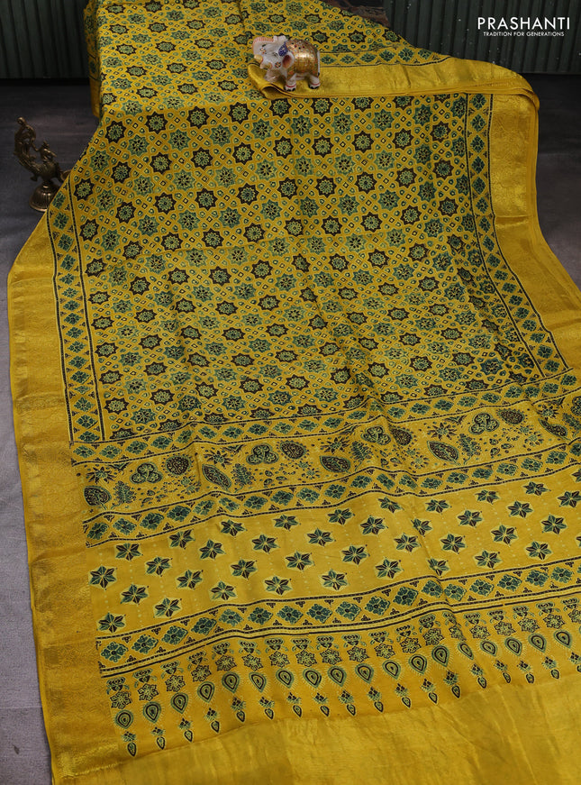 Dola silk saree yellow with allover ajrakh prints and zari woven border