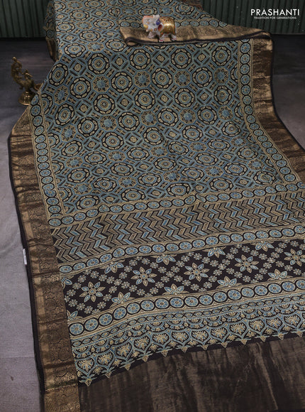 Dola silk saree blue shade with allover ajrakh prints and zari woven border
