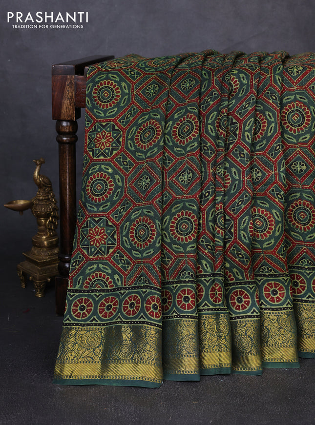 Dola silk saree green shade with allover ajrakh prints and zari woven border