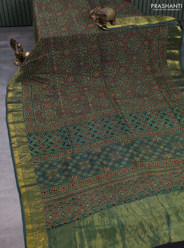 Dola silk saree green shade with allover ajrakh prints and zari woven border