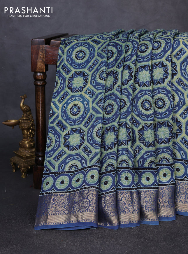 Dola silk saree blue shade with allover ajrakh prints and zari woven border
