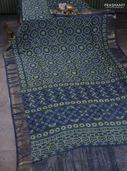 Dola silk saree blue shade with allover ajrakh prints and zari woven border