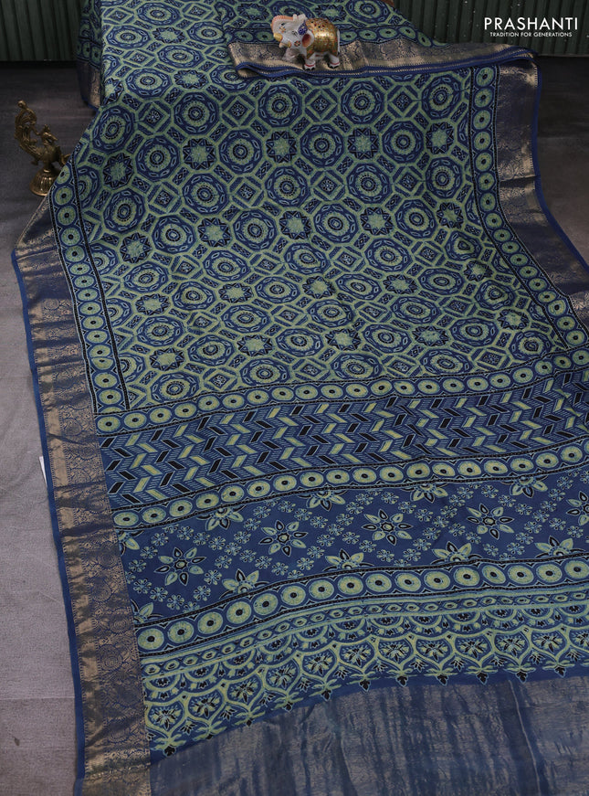 Dola silk saree blue shade with allover ajrakh prints and zari woven border