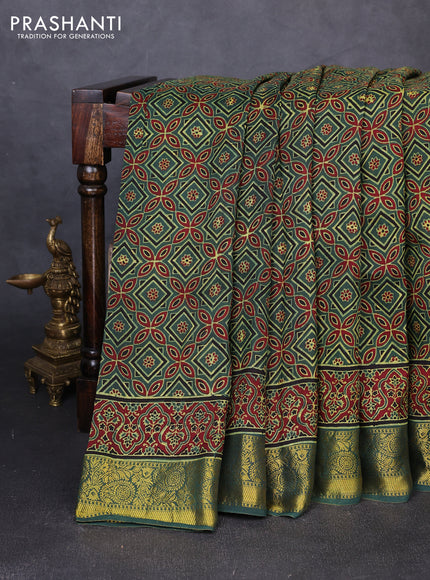 Dola silk saree green shade with allover ajrakh prints and zari woven border