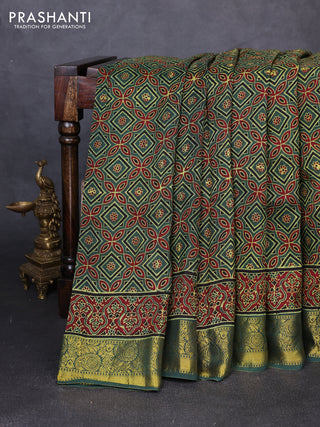 Dola silk saree green shade with allover ajrakh prints and zari woven border