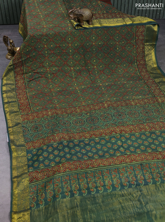 Dola silk saree green shade with allover ajrakh prints and zari woven border