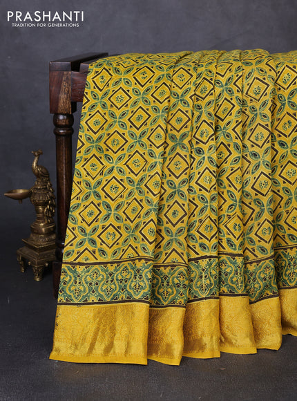 Dola silk saree yellow with allover ajrakh prints and zari woven border