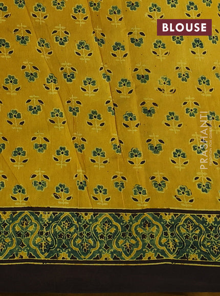 Dola silk saree yellow with allover ajrakh prints and zari woven border