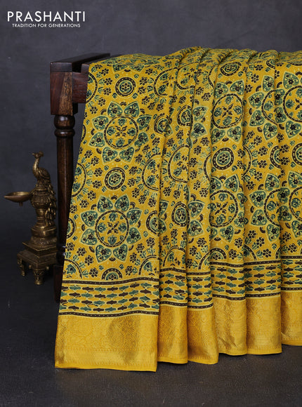 Dola silk saree yellow with allover ajrakh prints and zari woven border