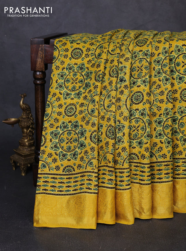Dola silk saree yellow with allover ajrakh prints and zari woven border