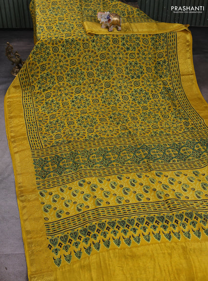 Dola silk saree yellow with allover ajrakh prints and zari woven border