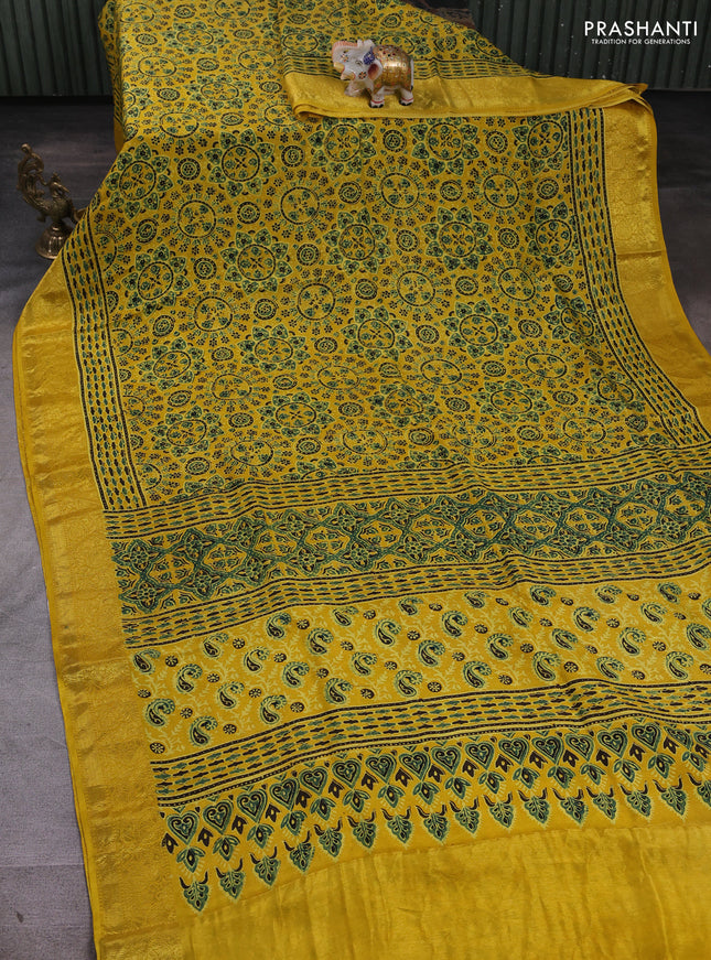 Dola silk saree yellow with allover ajrakh prints and zari woven border