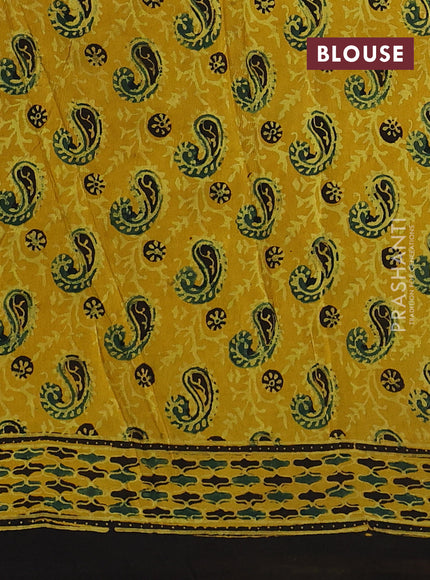 Dola silk saree yellow with allover ajrakh prints and zari woven border