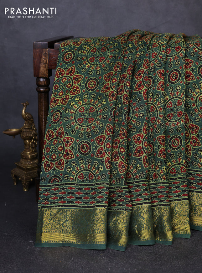 Dola silk saree green shade with allover ajrakh prints and zari woven border