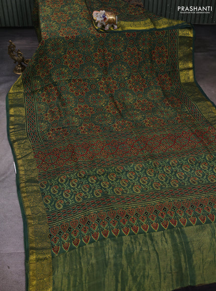 Dola silk saree green shade with allover ajrakh prints and zari woven border