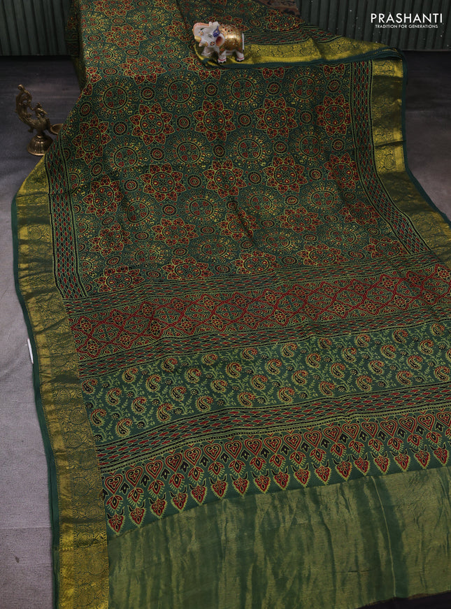 Dola silk saree green shade with allover ajrakh prints and zari woven border