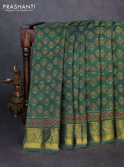 Dola silk saree green shade with allover butta prints and zari woven border