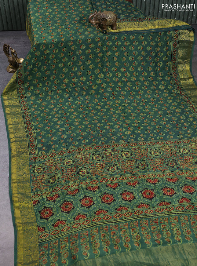 Dola silk saree green shade with allover butta prints and zari woven border