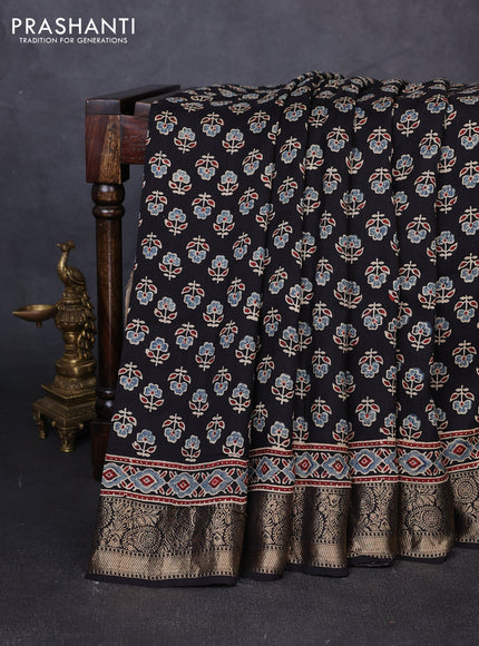 Dola silk saree black with allover butta prints and zari woven border
