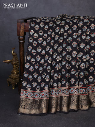 Dola silk saree black with allover butta prints and zari woven border