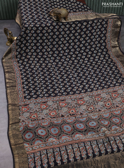 Dola silk saree black with allover butta prints and zari woven border