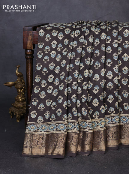 Dola silk saree blue shade and black with allover butta prints and zari woven border