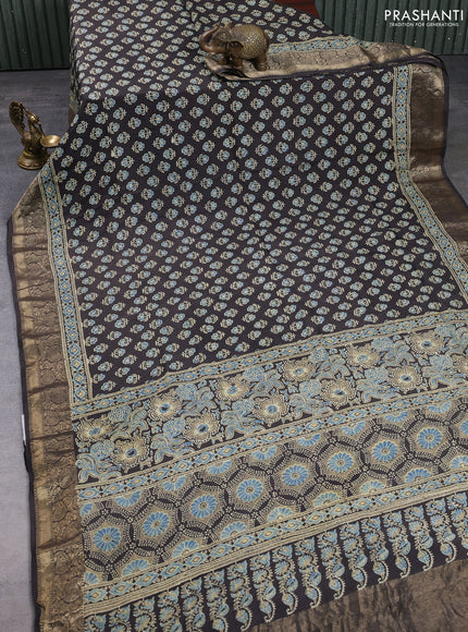 Dola silk saree blue shade and black with allover butta prints and zari woven border