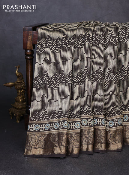 Dola silk saree black with allover ajrakh prints and zari woven border