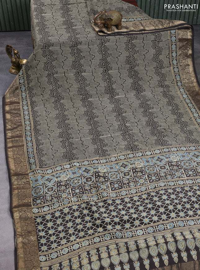 Dola silk saree black with allover ajrakh prints and zari woven border