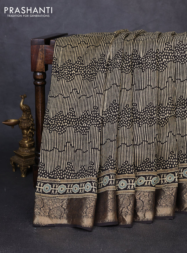 Dola silk saree blue shade with allover ajrakh prints and zari woven border