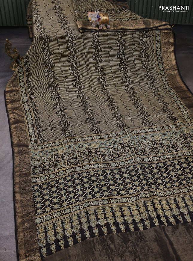 Dola silk saree blue shade with allover ajrakh prints and zari woven border