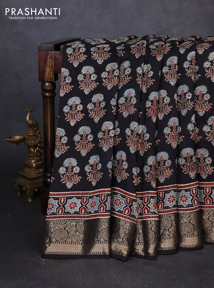 Dola silk saree black with allover ajrakh prints and zari woven border
