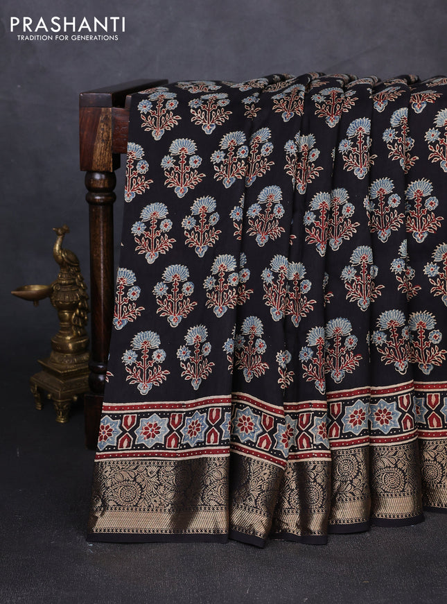 Dola silk saree black with allover ajrakh prints and zari woven border